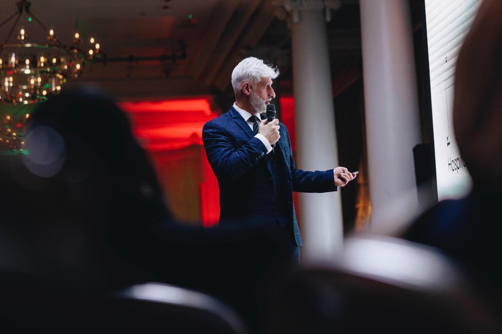 Professor Tas Qureshi speaking at a professional surgical event.